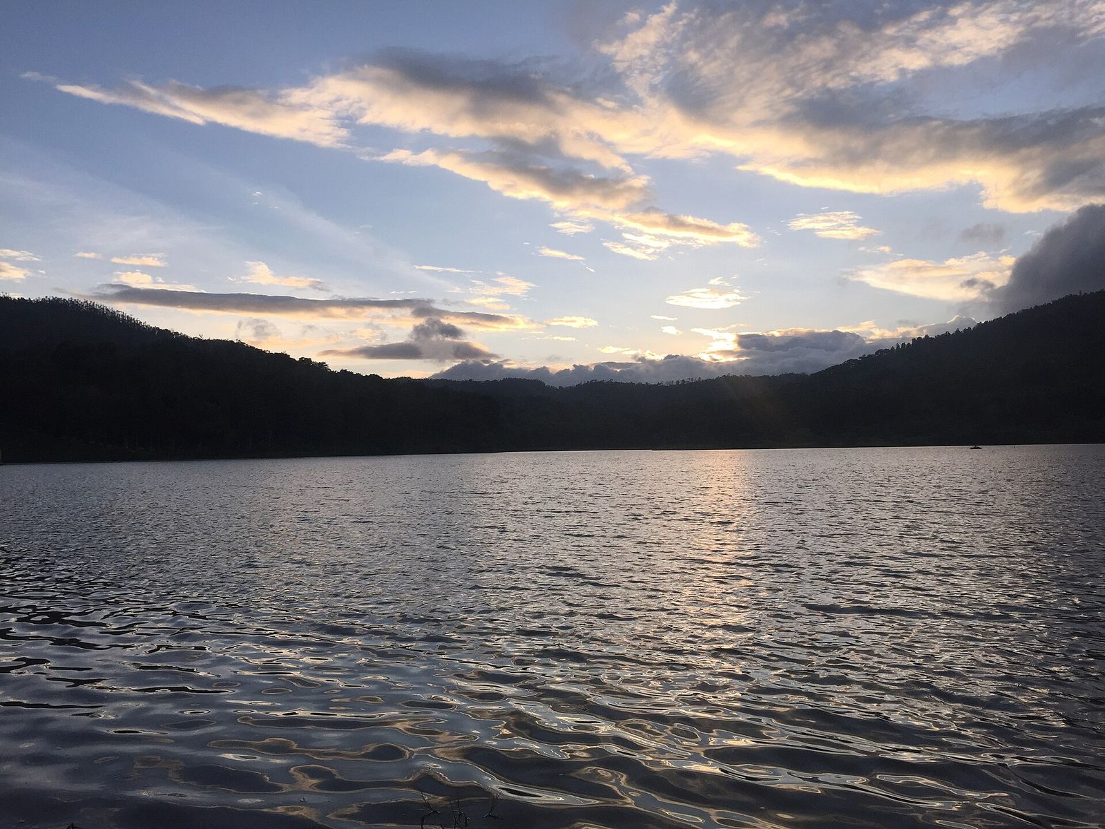 Hirekolale Lake with dark hills behind and evening clouds